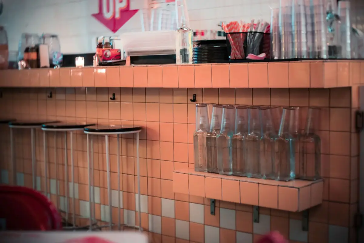 Tiled diner counter lined with chrome stools